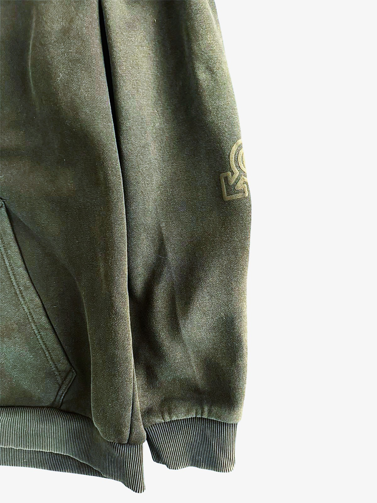 Green sweatshirt with a logo on the sleeve against a white background