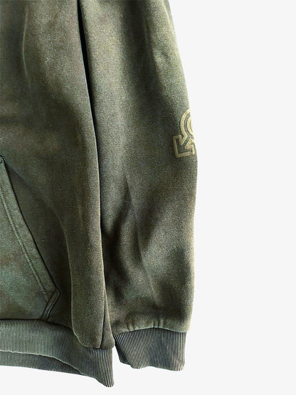 Green sweatshirt with a logo on the sleeve against a white background